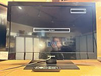 Front view of TV powered on showing "No Signal" message