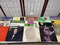 Group shot of 12 LPs laid out on table