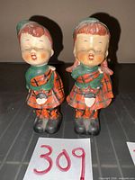 Front view of both Scottish Highland child figurines