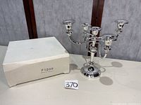 Candelabra alongside original box showing complete lot