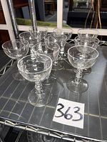 Full set of 10 etched coupe glasses on shelf