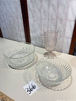 Lot overview showing two clear bowls and pink pedestal vase