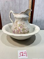 Pitcher resting inside basin displaying floral decoration and overall appearance