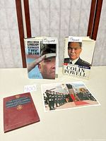 Group shot of two signed books, Constitution booklet, and photograph