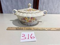 Covered tureen side view with lid on, ruler for scale