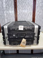 Front view of black 6U rack flight case showing handle, latches and aluminum trim