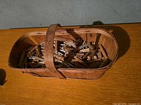 Wooden basket filled with wood clothespins
