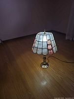 Lamp full view lit showing shade and base