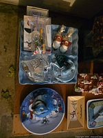 Overview of clear glass dishes, Santa ornaments, blue tray