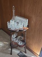 Entire collection on small table: decanter, tumblers, boxed piece and stemware shown
