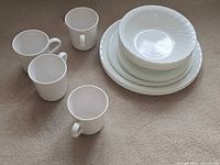 Overall view showing four mugs and stacked plates/bowl