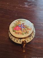 Top view showing painted courting couple scene on lid