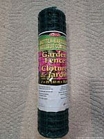 Front view of rolled green plastic garden fence in packaging showing brand, line and dimensions