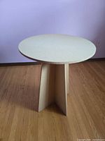 Beige MDF interlocking base with circular board top displayed