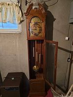 Front view of grandfather clock showing full height and interior components