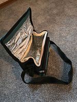 Open insulated lunch bag showing foil interior and strap