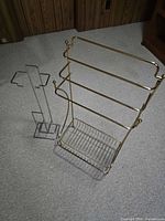 Gold-tone three-bar rack and chrome-tone slim stand overview