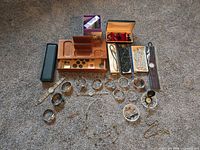 Overview of all jewelry pieces, watches, boxes on carpet