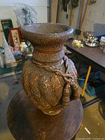 Full view of ceramic vase showing texture and rope