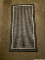 Full view of rectangular outdoor rug showing color, pattern and borders