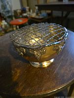 Angled view showing entire rose bowl with wire frog and grapevine detailing