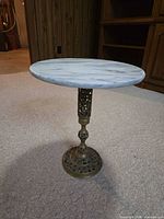 full view of side table showing marble top and metal pedestal