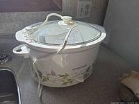 White Hamilton Beach floral patterned slow cooker with glass lid and power cord