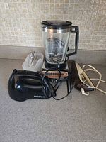 Overall lot showing blender, hand mixer, attachments and carving knife