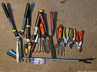 All twelve garden tools laid out on ground