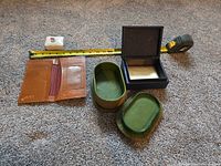 All four items arranged with measuring tape for scale