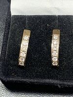 Front view of both earrings in display box