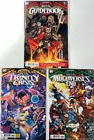 Group shot of the three bagged and boarded Dark Nights: Death Metal #1 issues: Guidebook, Trinity Crisis, Multiverse's End