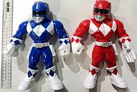 Front view of both Blue and Red Ranger figures beside ruler for scale