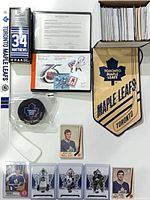 overview of entire lot including cards, pucks, mini stick, pennant, stamp booklet