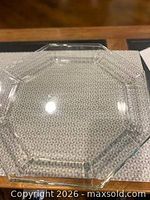 Single clear glass hexagonal side plate on table