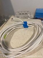 Coiled white Cat 5 cable with connectors visible