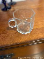 Single clear hexagonal glass cup with handle