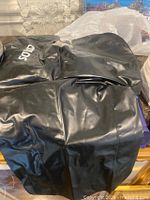 Top view of black inflatable adult life vest showing material and printed text