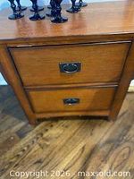 Front view of oak Mission style night stand showing two drawers and hardware