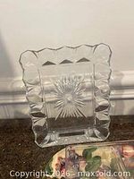 Overall view of sculptured glass picture frame showing faceted border and starburst design