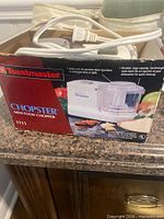 Retail box showing Toastmaster Chopster Mini Food Chopper model 1111 and power cord