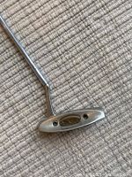 Close-up of putter head showing STX badge and soft face insert