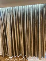 Front view of full length gold-green drapes