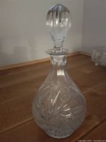 Full view of cut crystal decanter with faceted stopper