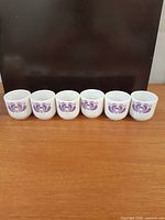 Front view of six Hollóháza porcelain shot glasses