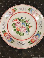 Front view of Hollohaza porcelain wall plate showing full floral folk design