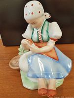 Front view of porcelain figurine showing full design and colors