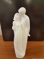 Front view of glossy white porcelain couple figurine