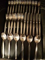 Layout of 12 dessert forks, 6 dinner forks, 6 dinner knives, 6 tablespoons