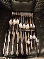 Place settings showing knives, forks and two spoon sizes